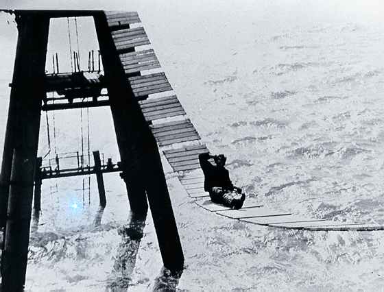 Engineer Tony Pine rests on catwalk during its construction